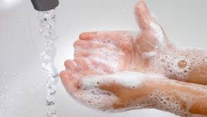 Image from Infection Control Today website showing a child's hands being covered in soap under running water at a sink. 