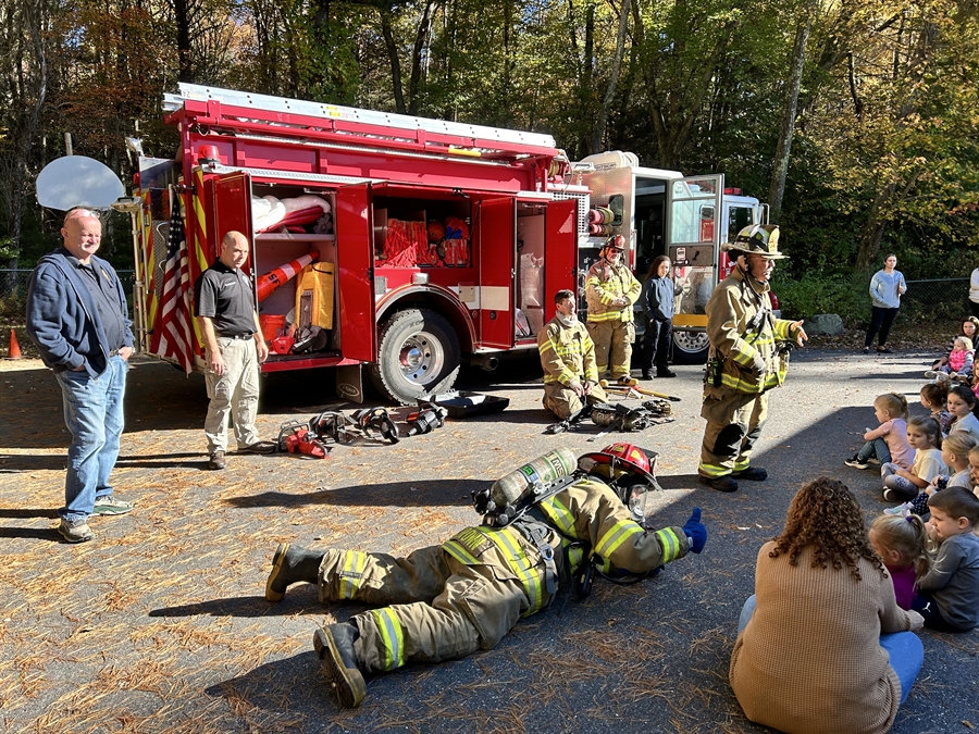 Firefighter showcasing a belly crawl to WSS students