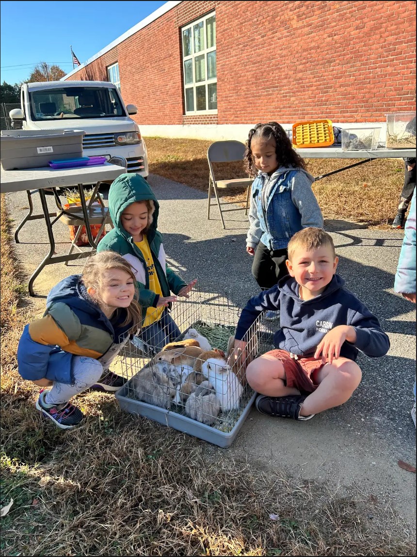 Students smiling with animals