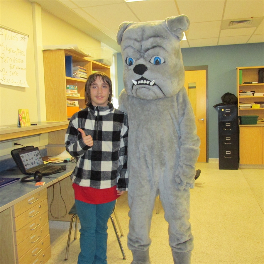 Picture of most improved student with school mascot.