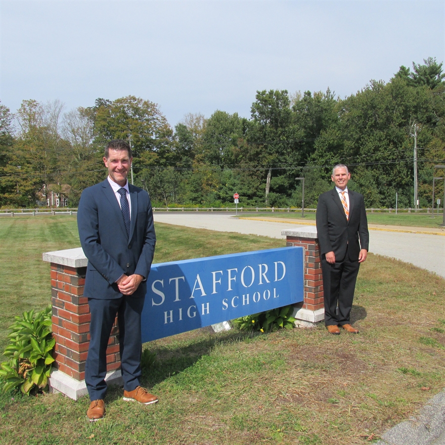 Principal Marco Pelliccia and Assistant Principal Ben Scurto standing in front of the Stafford High School sign outside the front of the high school.