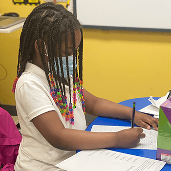 Girl writing at table