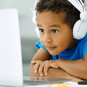 Boy with headphones working on computer