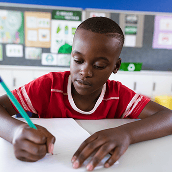 Boy writing at desk