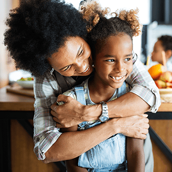 Mom and daughter smiling