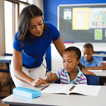 Teacher helping student at desk