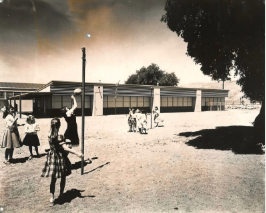 Students playing at recess on the playground, 1960's 