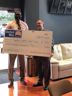 Principal Presley being awarded the 2020 grant from the CEO of United Way of Lake and Sumter 