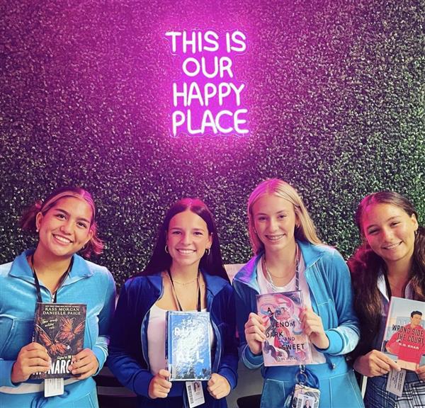 Students posing with Library books