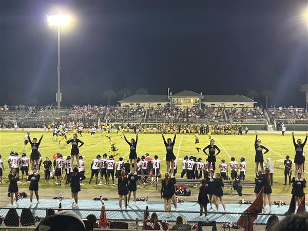 Cheerleaders performing at football game