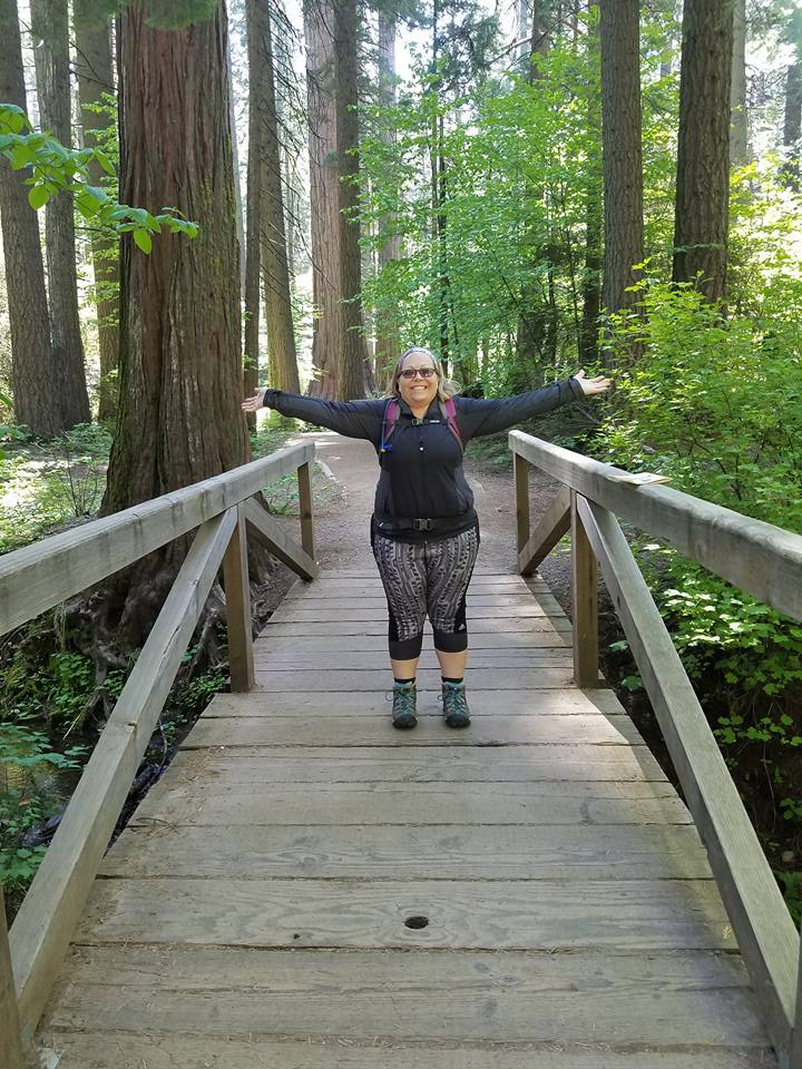 ms hamilton standing on a wooden bridge in the middle of the forrest ms hamilton standing on a wooden bridge in the middle of the forrest