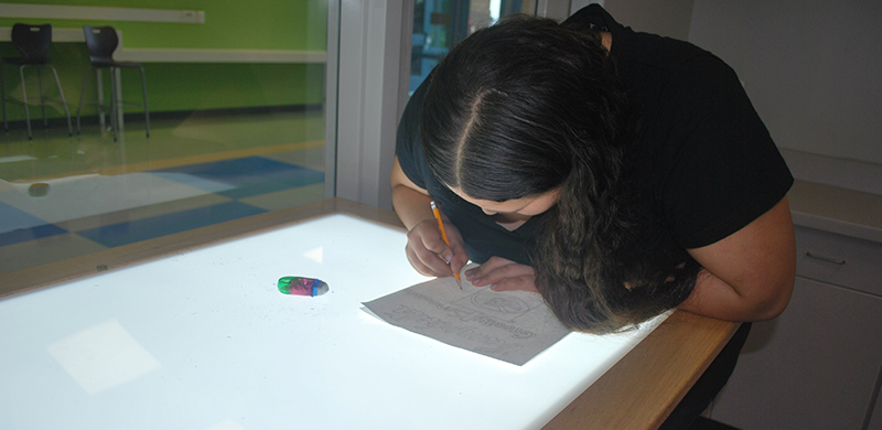 Student at a lightbox