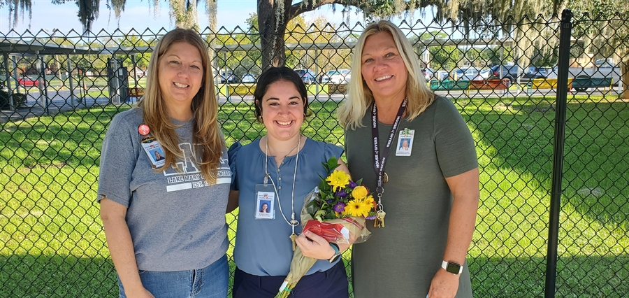Mrs. Little and Mrs. Bornemann present Teacher of the Year award to Mrs. McKnight