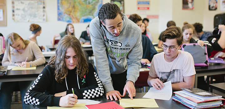 teacher working with students