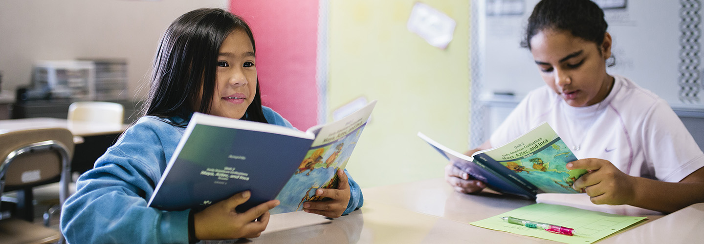 Two students reading in class