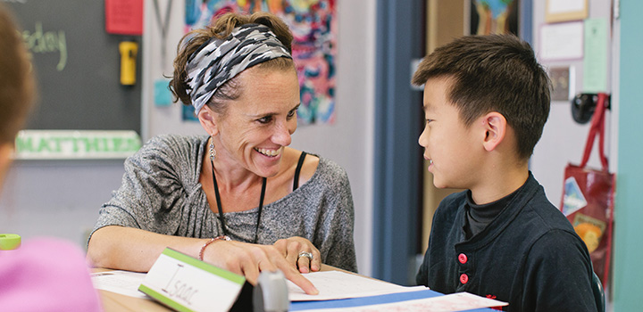 Teacher working with a student.