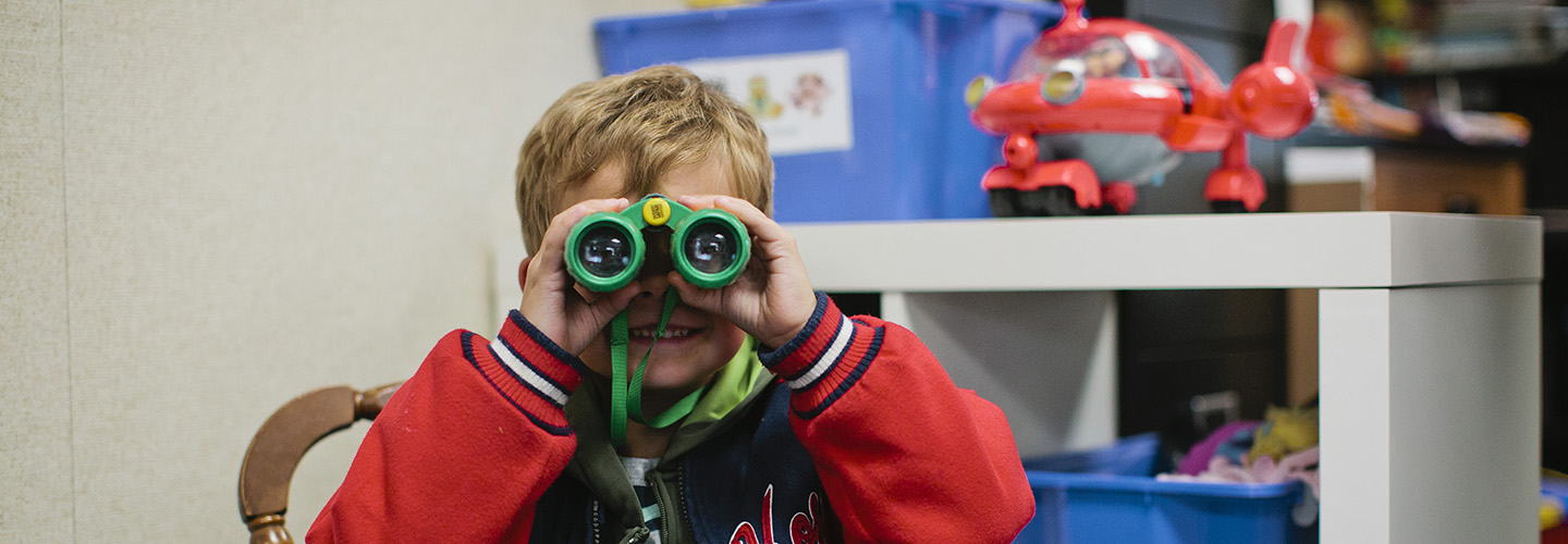 Student looking through binoculars 