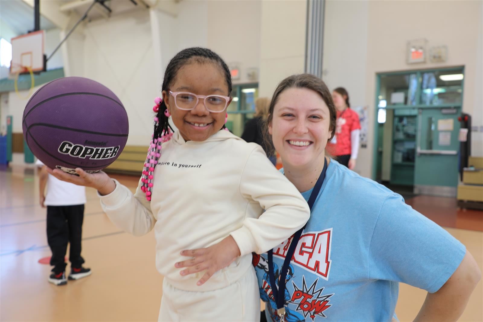 student and staff member smiling