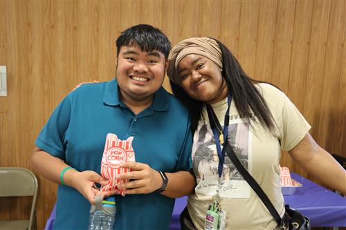 student and staff smiling