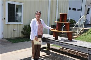 Grace Fornicola standing next to her retirement gift