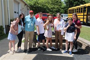 Vanguard students presenting Grace's retirement gift