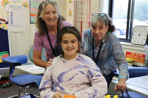 student and staff smiling