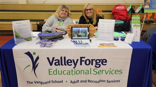 two staff members at resource table