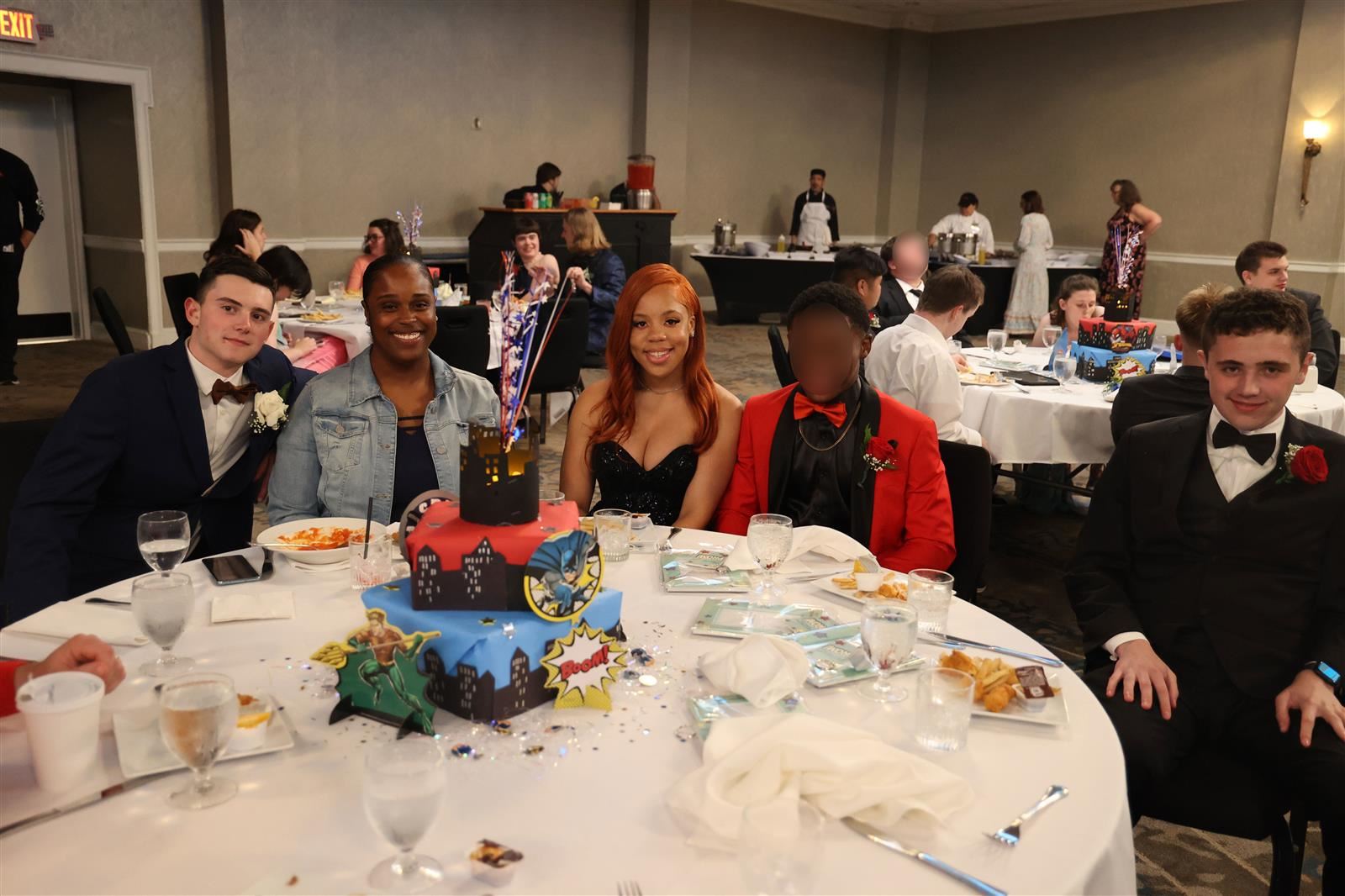 alumni and staff posing at prom