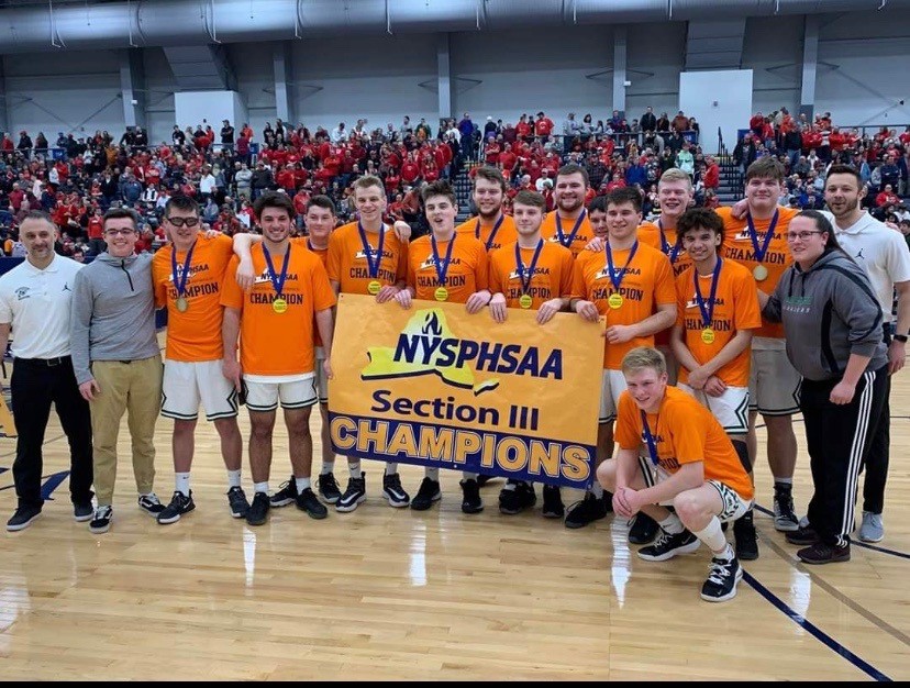 The Weedsport boys basketball team poses with the Sectional banner