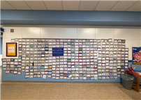 Over 100 projects hung up on the wall in a quilt pattern thumbnail265370