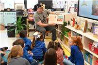 Staff member reads to students thumbnail264830