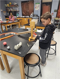 student with recently created Rube Goldberg machines thumbnail264919