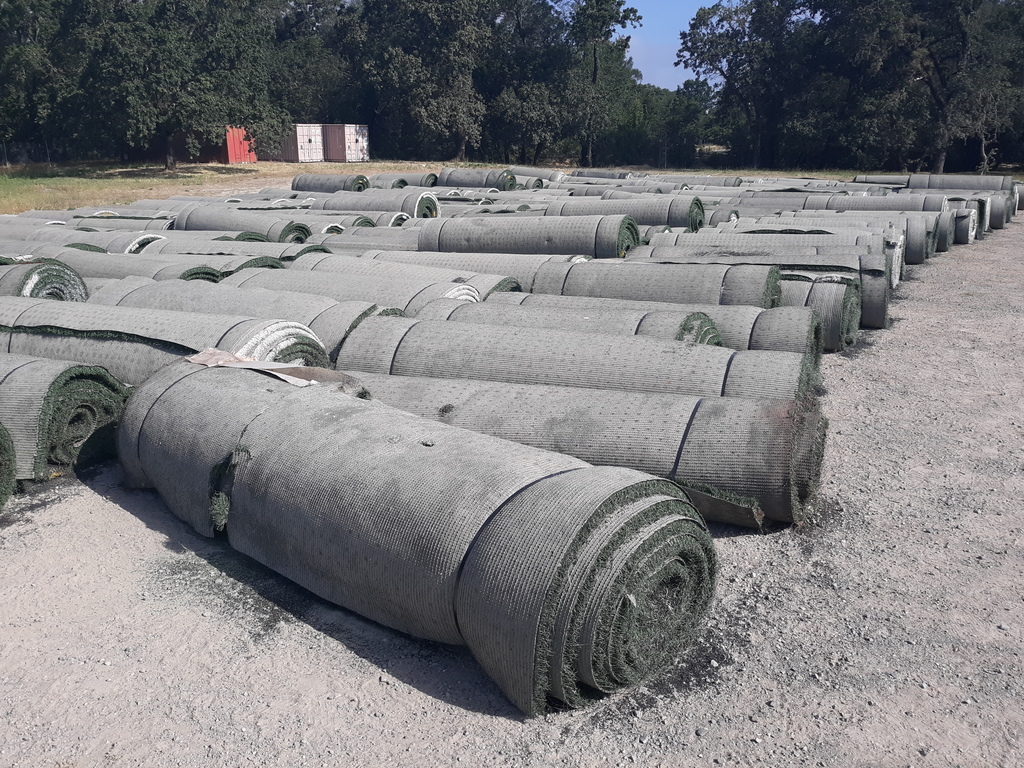 Old turf rolled up for removal