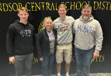 Waddell Family in front of a banner