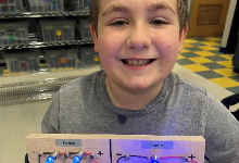 Boy holding a circuit board
