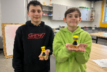Two boys holding trophies