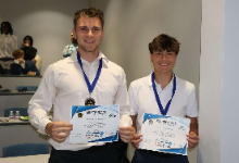 Two Teenage boys holding certificates