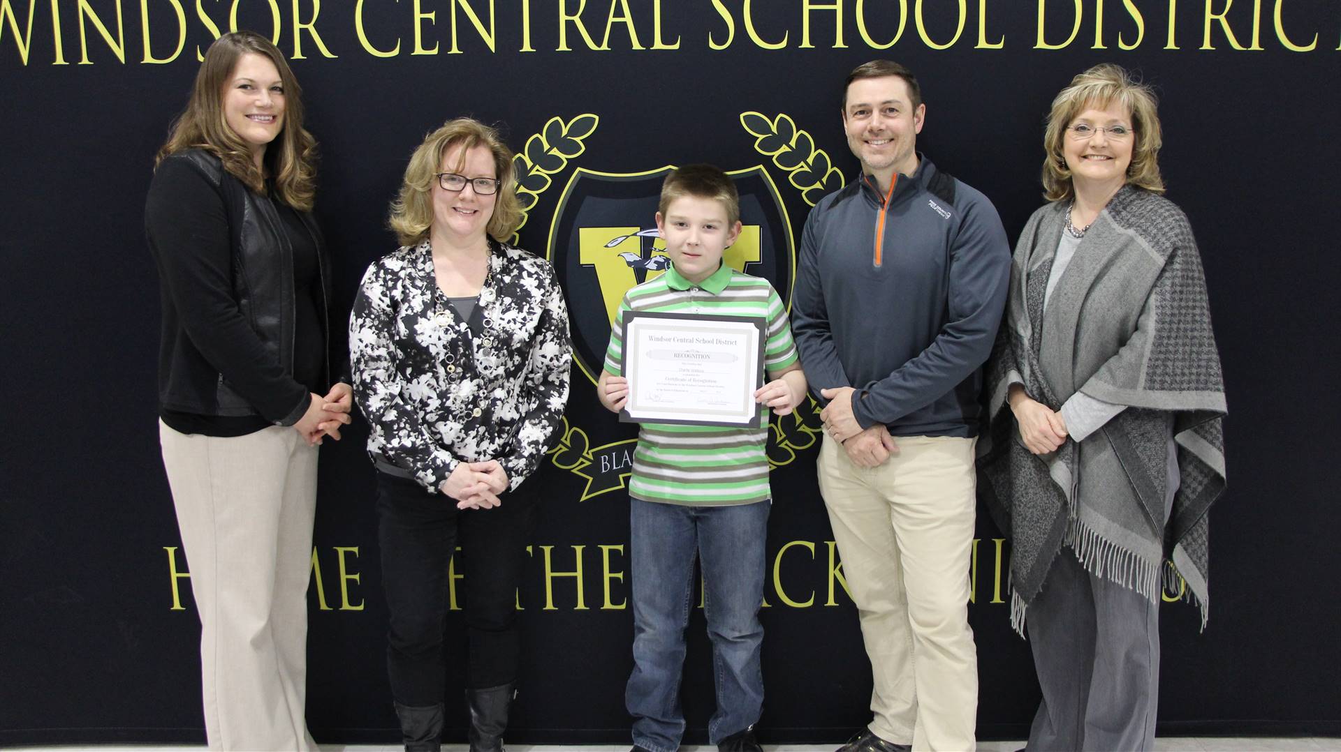 Charlie Watkins holds up certificate