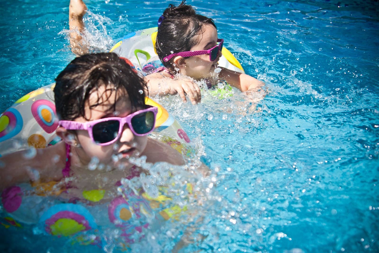  kids swimming in float