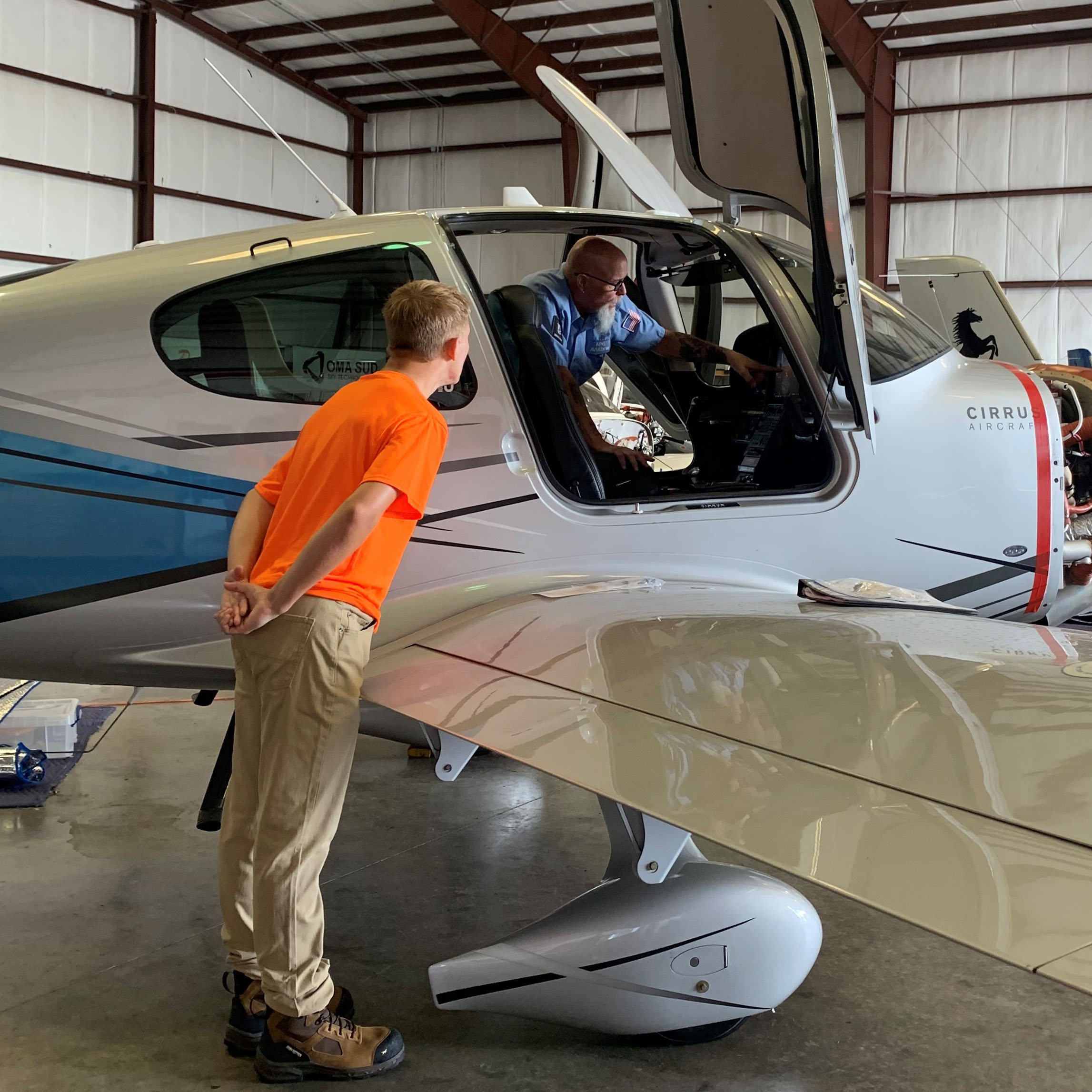 teacher showing student plane parts