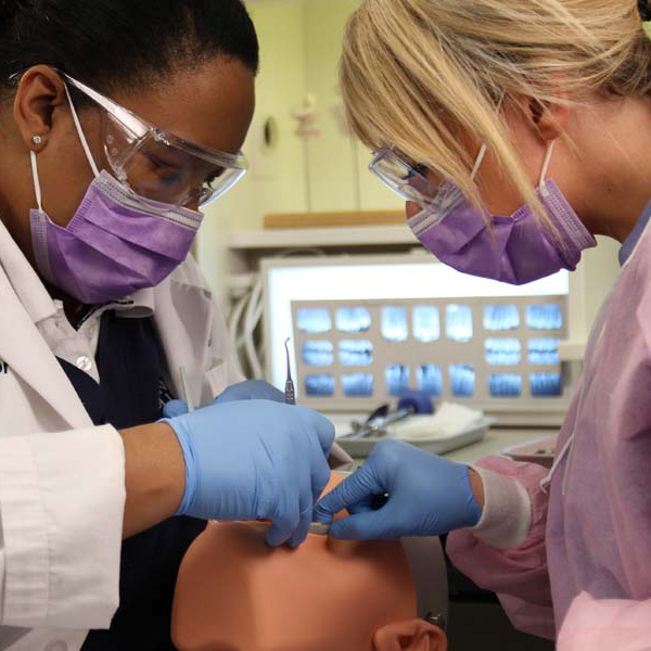 students practing dental techniques in class at CTC