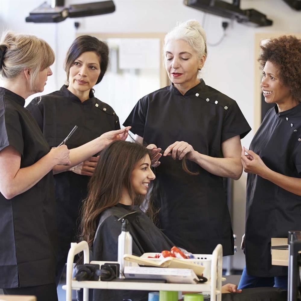 Hairstylists teaching how to cut hair.