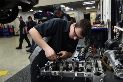 Automotive Maintenance and Light Repair student working using tools.