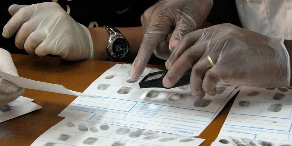 Technicians analyzing finger prints.