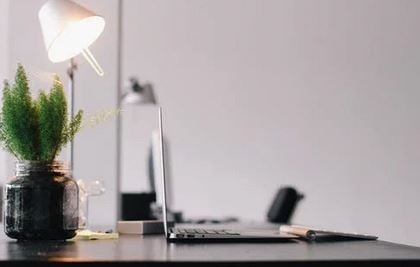 Picture of a desk with laptop on it.