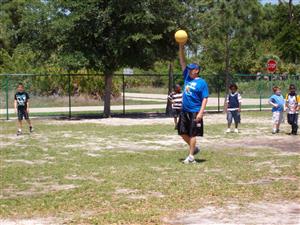 Mr. Rogala playing kickball with students.