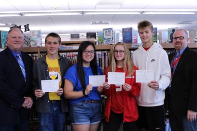 two male students and two female students hold certificates