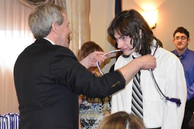 a young man receives an award