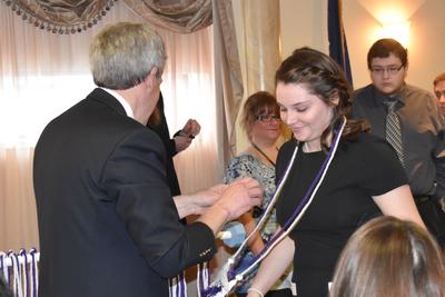 a young woman receives an award