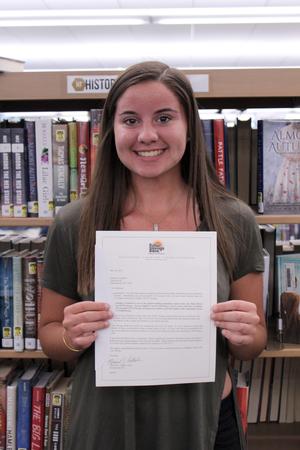 a girl holds a certificate